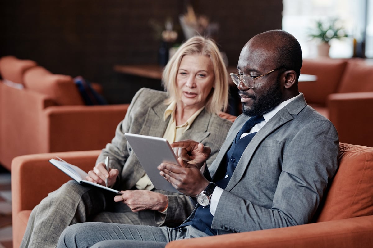 Business consultants reviewing process plans together on a tablet