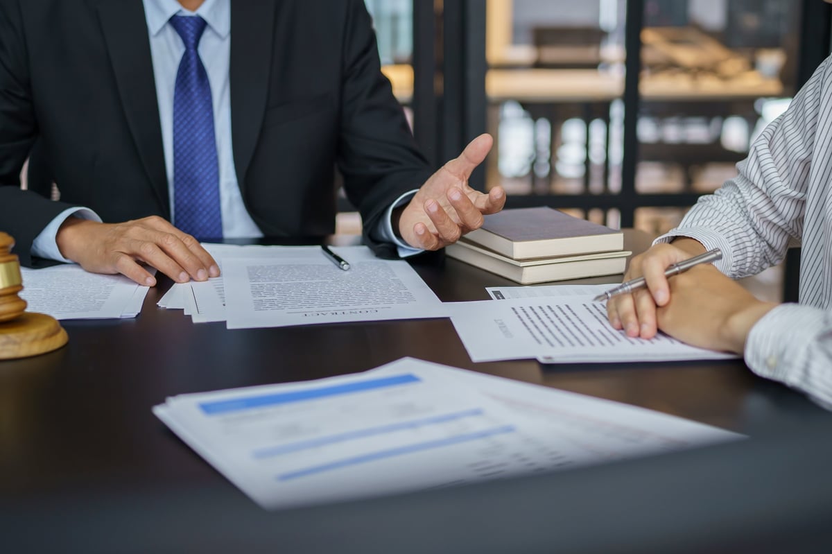 Two professionals reviewing a signed agreement