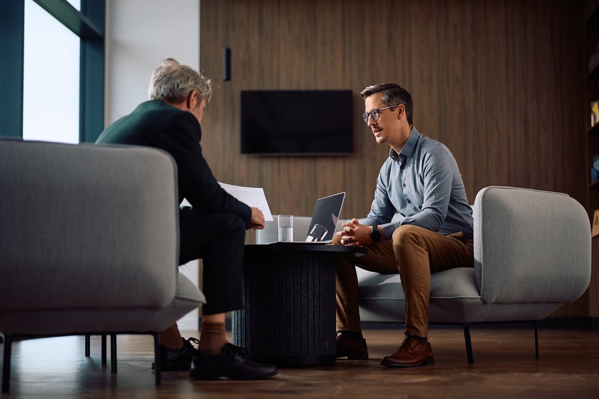 Business owner and advisor analyzing reports during a meeting